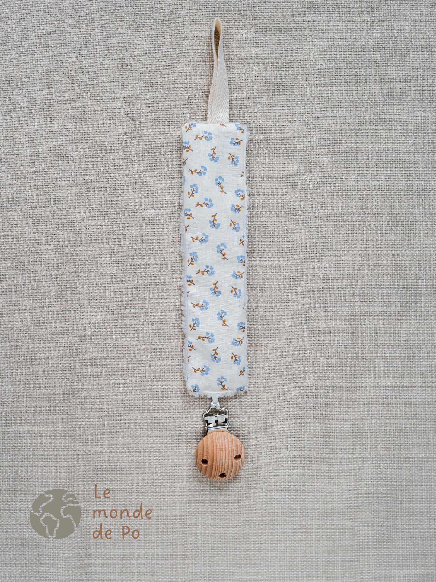 Attache tétine fleurs bleues